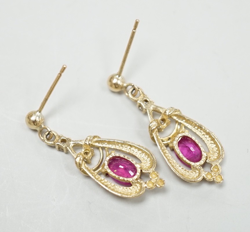 A modern pair of 9ct, ruby and diamond set drop earrings, 26mm, gross weight 2.5 grams.